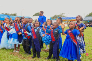 Preschool and graduating students in colorful attire smiling while receiving awards at Powerfields Schools, a top school in Ikorodu and Lagos
