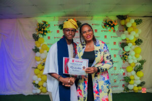Year 12 graduates in colorful outfits smiling and receiving awards at Powerfields Schools valedictory service, a top boarding school in Lagos