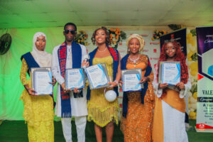 Year 12 graduates in colorful outfits smiling and receiving awards at Powerfields Schools valedictory service, a top boarding school in Lagos